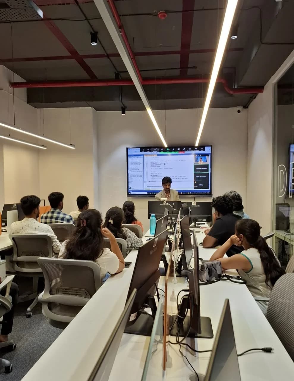 A live SQL session: an instructor walks a room of students through code on screen